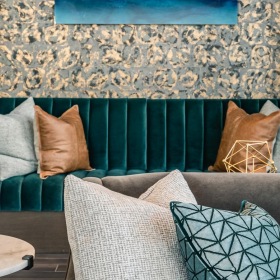 Community couch with pillows inside Haven North Andover's lounge