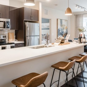 a kitchen with an island and chairs