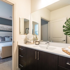 a bathroom with a bed and sink