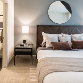 a bedroom with a large mirror